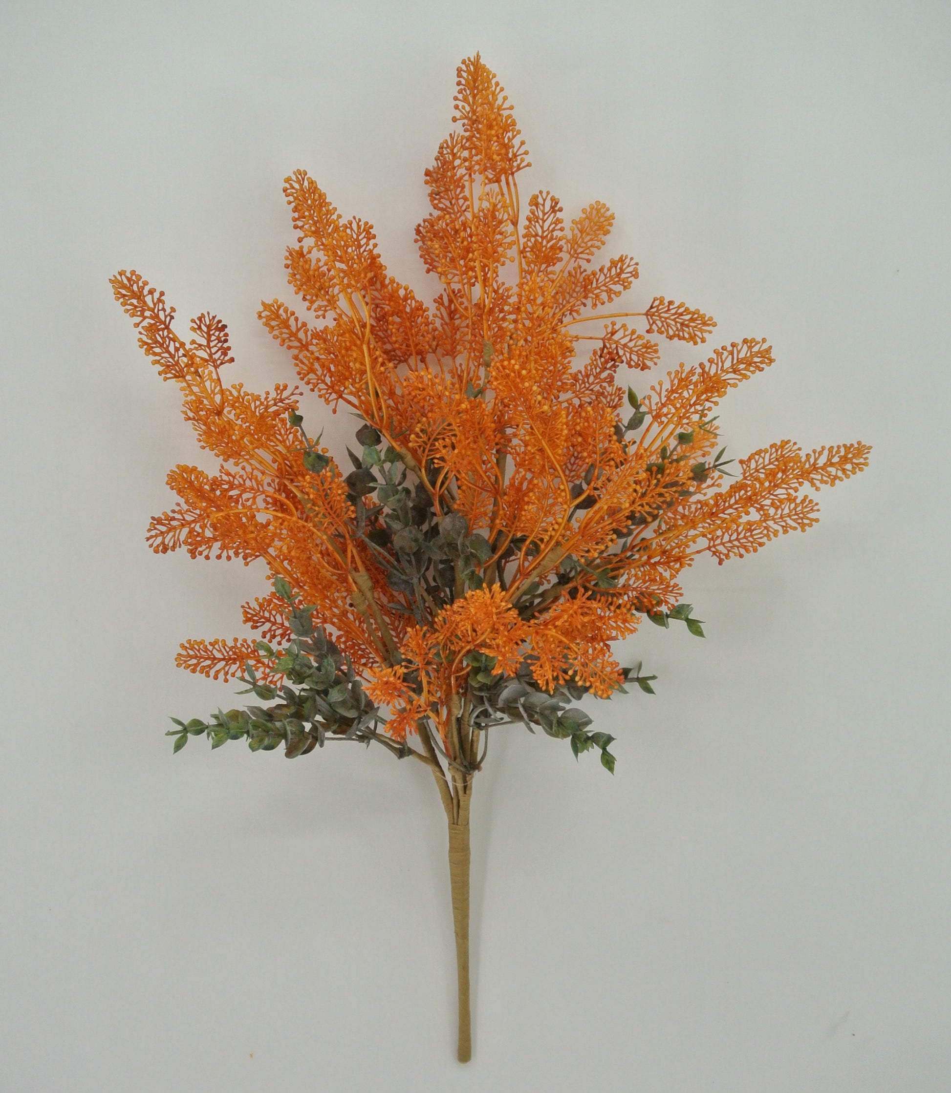 A bouquet of orange and green artificial flowers is displayed against a white background.