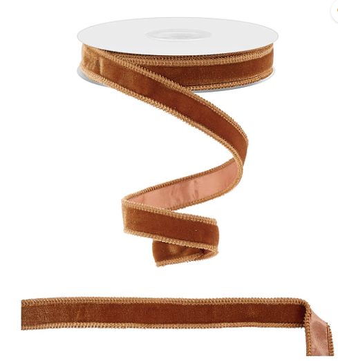 a brown velvet ribbon with a gold trim, which is a decorative and luxurious material often used for embellishing various items.