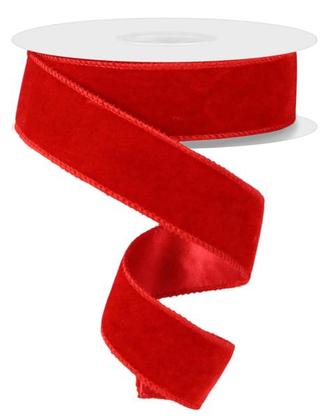 a roll of red satin ribbon on a white background