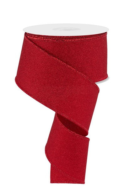 a roll of red glitter ribbon on a white background