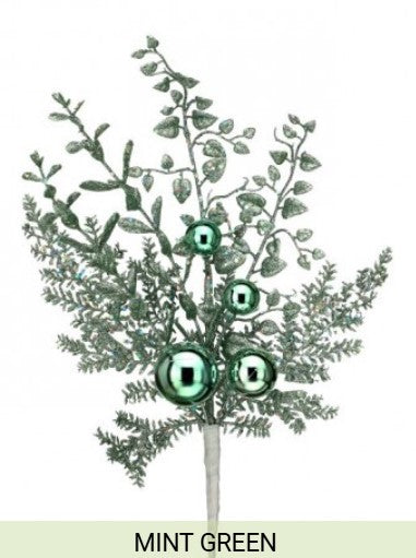A branch with green leaves and three green balls, resembling a Christmas ornament, is depicted in the image.