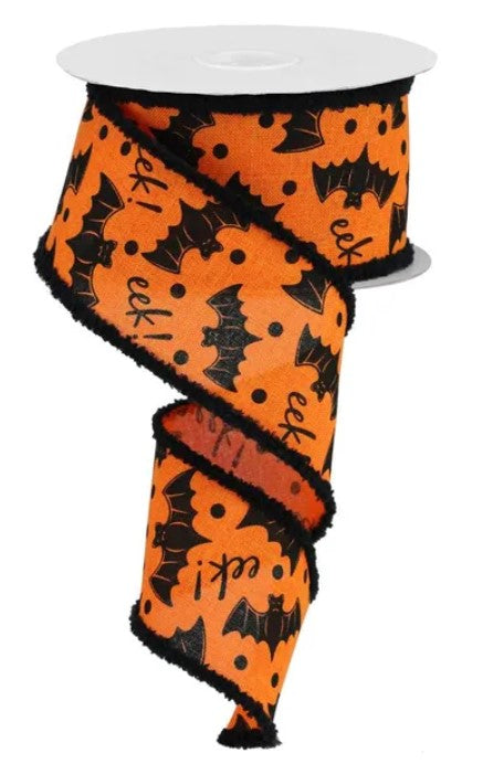 a spool of orange and black bat-themed ribbon.