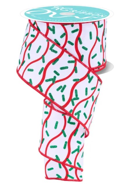 A roll of ribbon with a pattern of red and green swirls and dots.