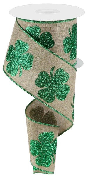 a roll of green glitter ribbon with shamrocks on it