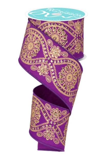 a purple and gold decorative ribbon with a floral pattern.