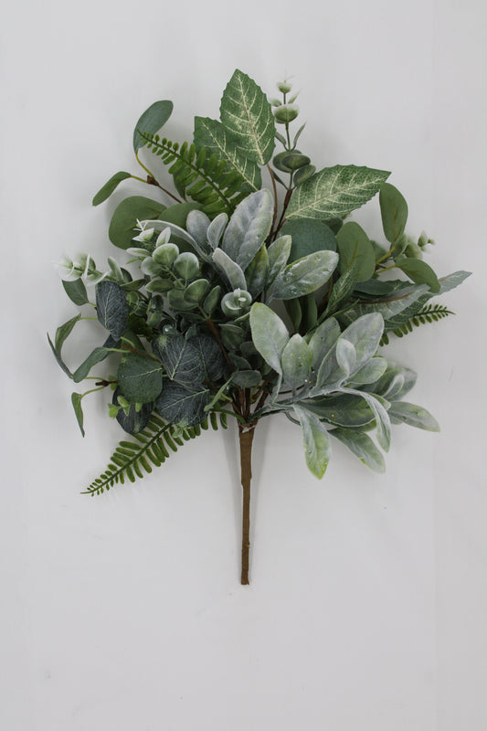 A bouquet of various green leaves and ferns arranged on a white background.
