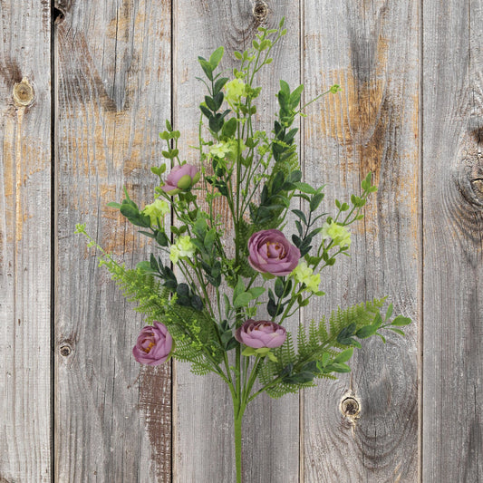 A bouquet of purple and green flowers is displayed against a weathered wooden background.