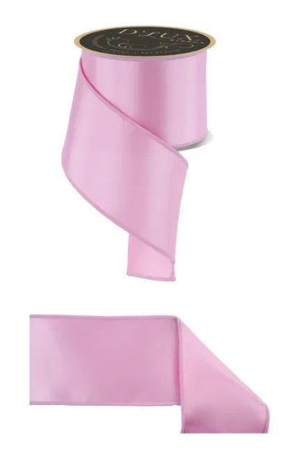 a pink ribbon with a black label, and there is a smaller pink ribbon below it.