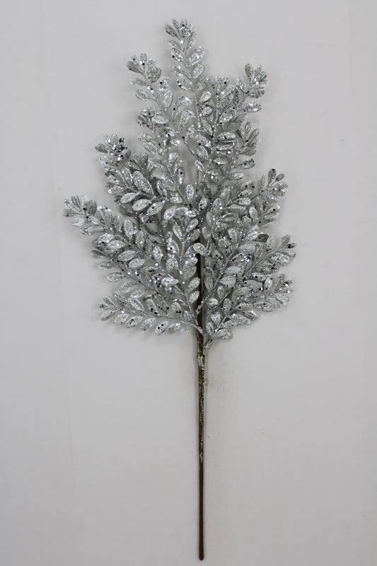 A silver leafy branch with small, shiny leaves attached to it, creating a decorative and elegant appearance.