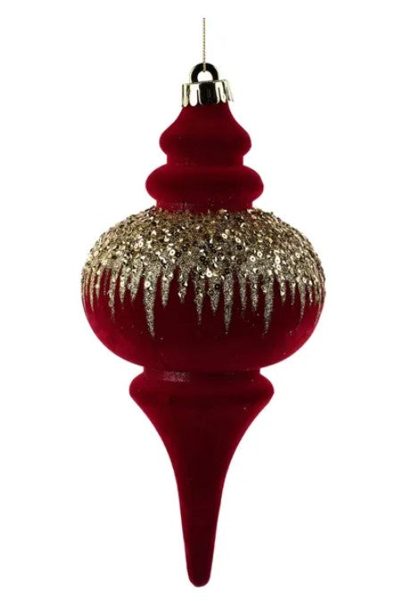 A red glass ornament with a pointed top and a spout, decorated with glitter and icicles.