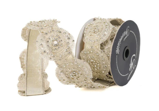 a decorative beige ribbon with a silver embellishment, possibly a lace or beaded design, and a spool of ribbon with a black label.