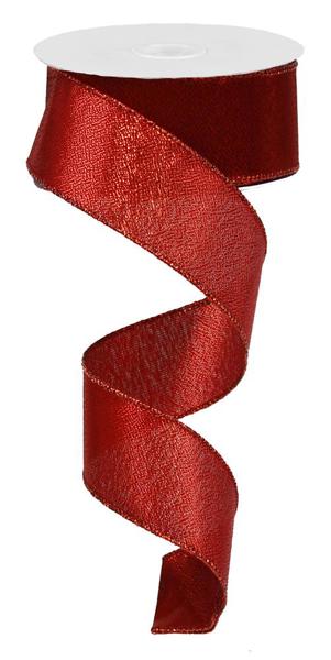 a roll of red satin ribbon on a white background