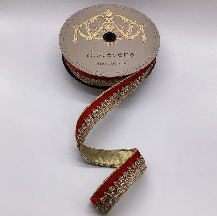 A roll of decorative ribbon with a gold and red pattern, featuring a decorative design on the top of the ribbon.