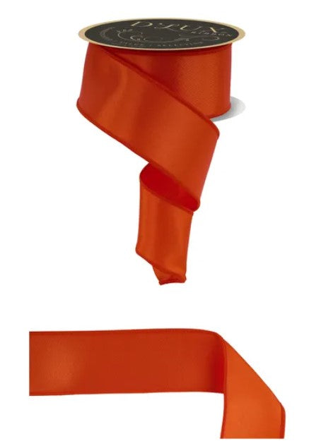 a red ribbon with a black label, and a plain red ribbon.