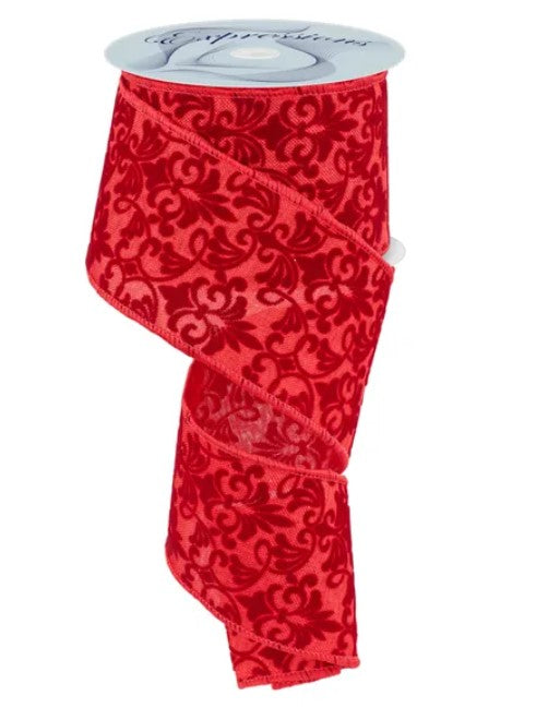 a red, floral-patterned ribbon with a silver-colored spool of ribbon attached to it.