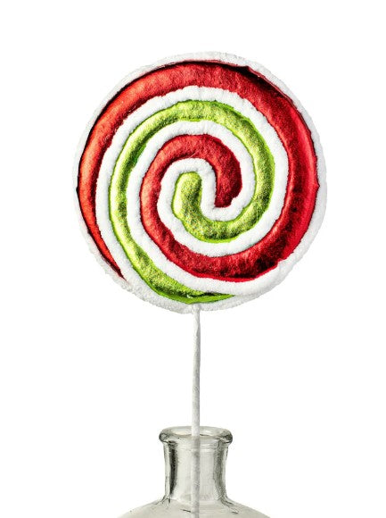 a lollipop sitting on top of a metal vase