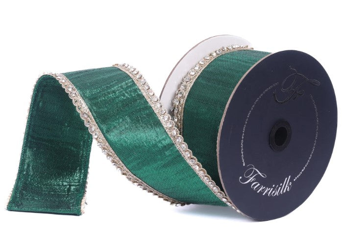 A roll of green and silver metallic ribbon with a decorative trim, placed on a white background.