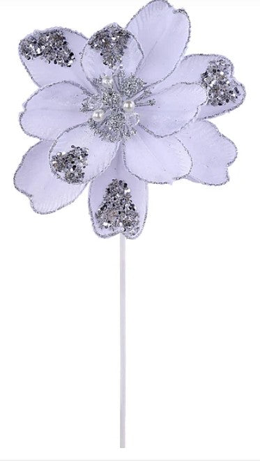 A decorative purple flower with silver glitter accents, attached to a white stick.