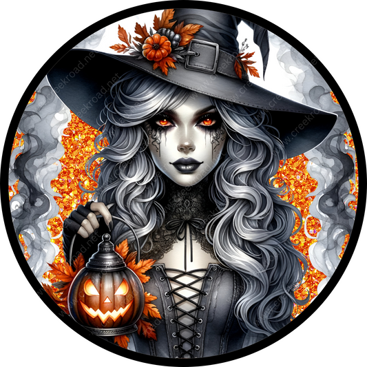 a woman in a witches costume holding a lantern
