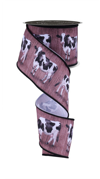 a roll of ribbon with a picture of a cow on it