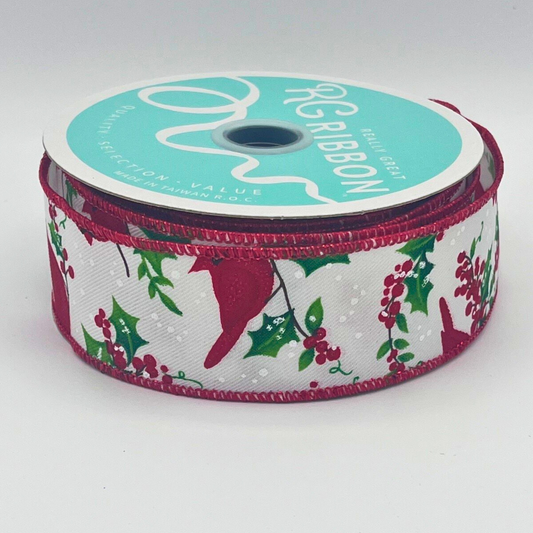A spool of turquoise ribbon with a red and white pattern of holly and berries, placed on a white surface.