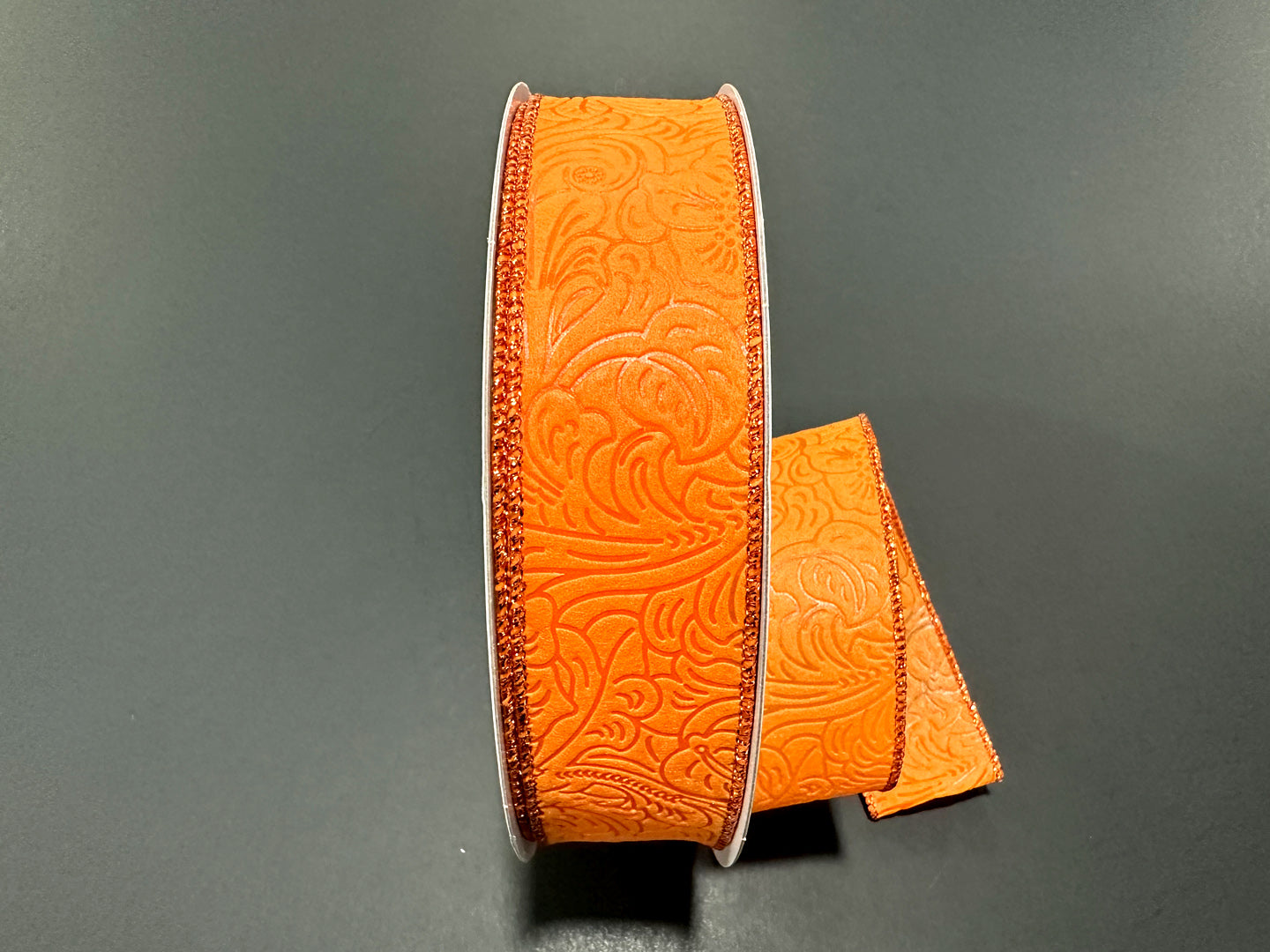 a pair of orange belts sitting on top of a table