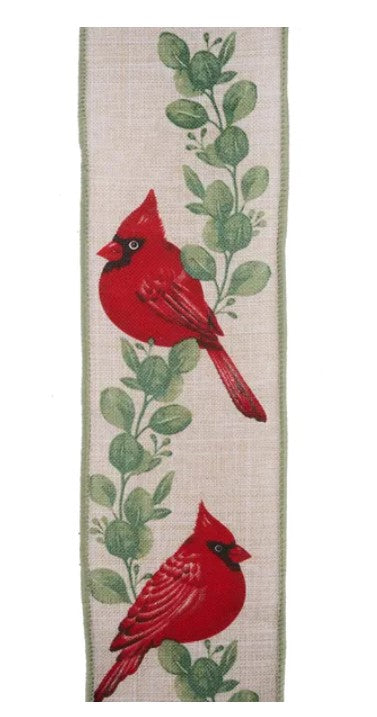 two red birds perched on branches with green leaves.