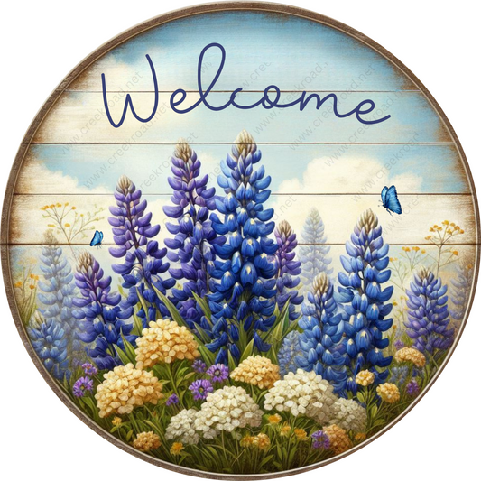 a welcome sign with blue and white flowers