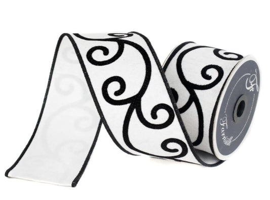 A roll of black and white decorative ribbon with a repeating black swirl pattern.