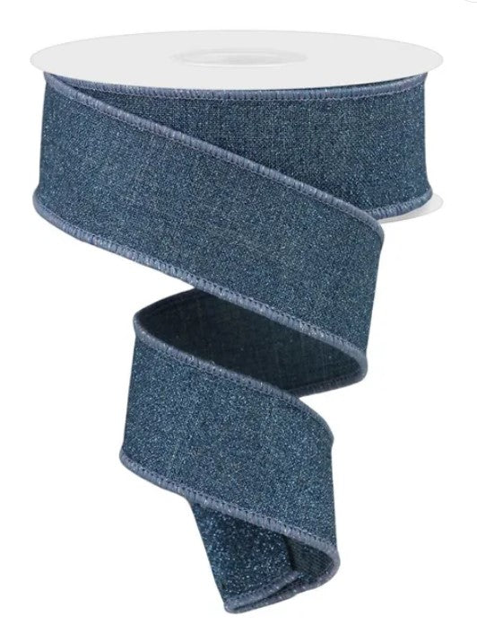 A roll of blue denim-like ribbon with a white top.