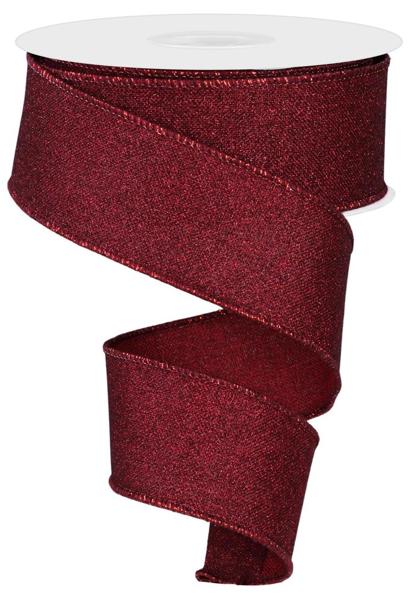 a roll of red glitter ribbon on a white background