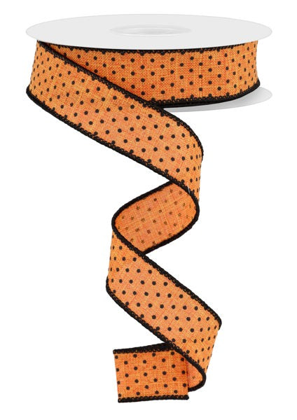 a roll of orange polka dot ribbon on a white background