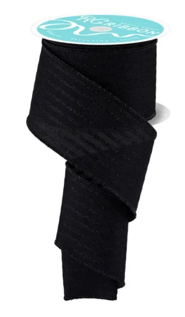 a roll of black ribbon with a turquoise label on top.