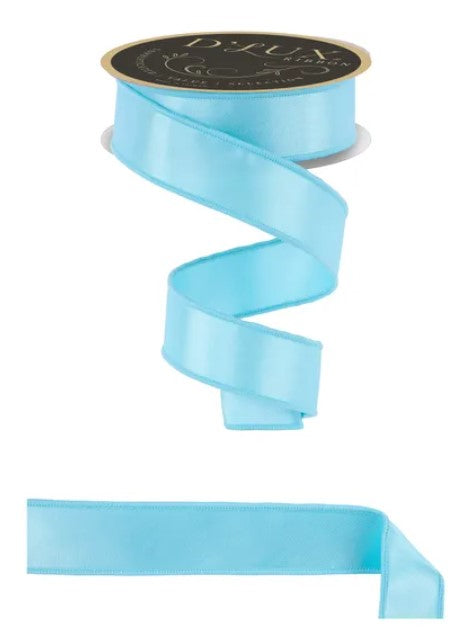 A roll of light blue satin ribbon with a gold label, and a plain light blue ribbon below it.