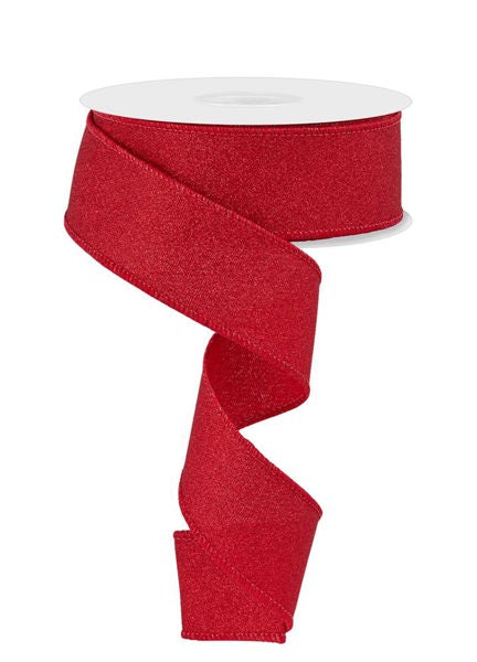 a roll of red glitter ribbon on a white background