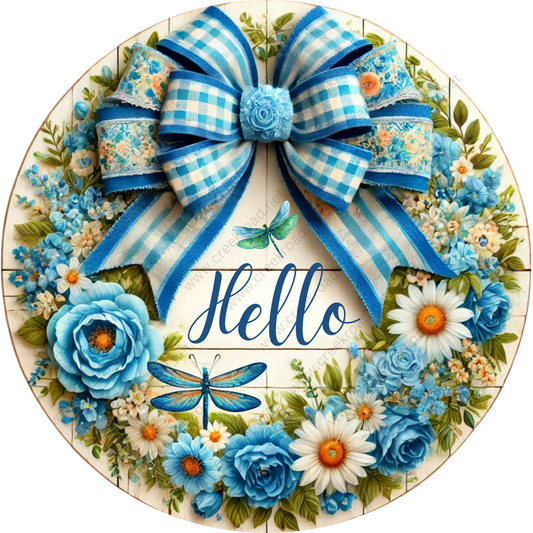 A decorative wreath made of blue and white ribbons, flowers, and a large blue bow. The word "Hello" is written in cursive on the wreath.