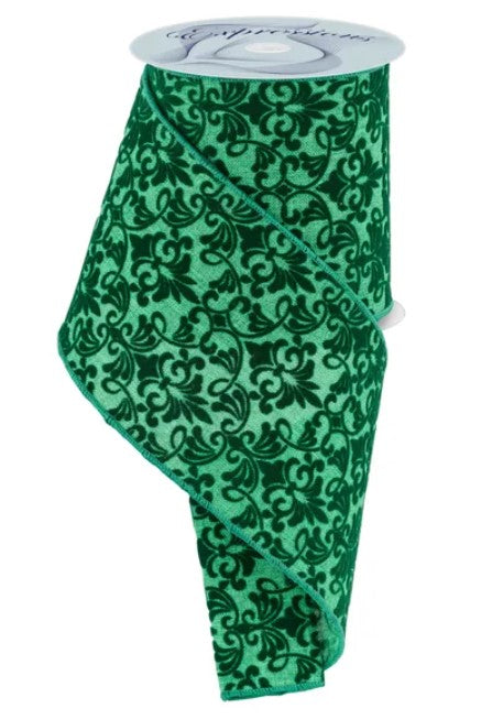 a roll of green and black floral patterned ribbon.