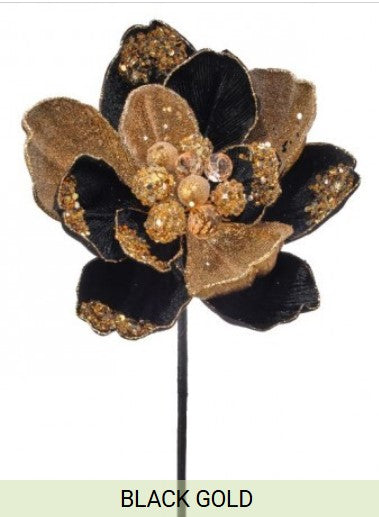 A black and gold flower-shaped ornament with a gold center and black petals.