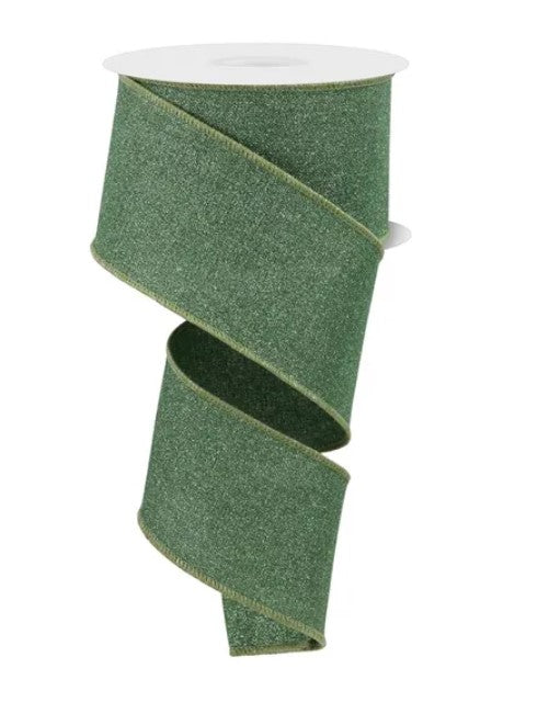 A roll of green glittery ribbon is shown against a white background.