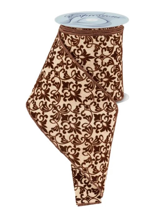 a brown and cream patterned fabric, possibly a ribbon, with a white label attached to it.