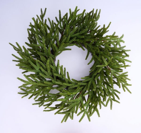 A wreath made of green pine needles or branches, creating a natural and festive appearance.