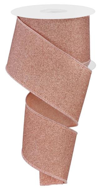 a roll of pink glitter ribbon on a white background