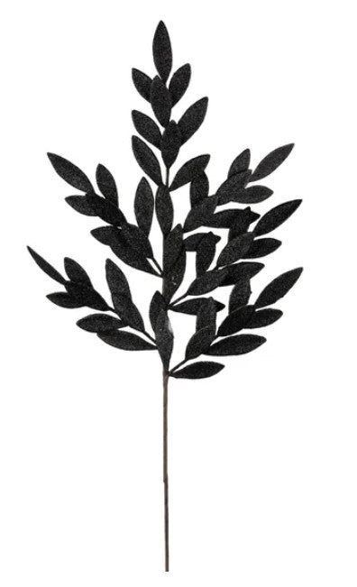 A black leafy branch with multiple dark leaf shapes, creating a striking silhouette against a white background.