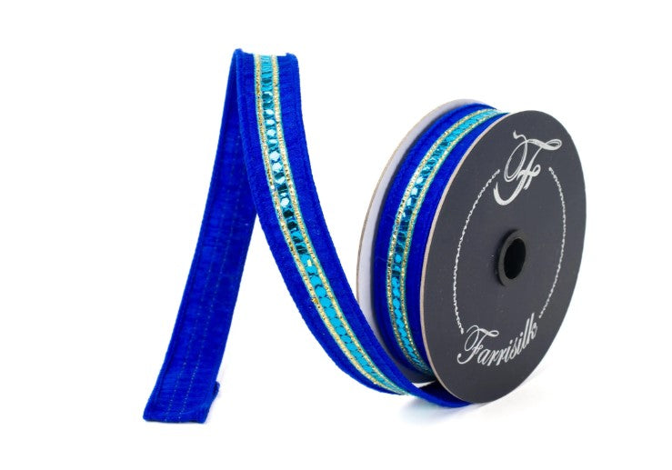 A roll of blue and turquoise embellished ribbon with a silver sequin trim.