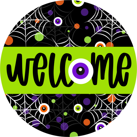 a black and green welcome sign with spider webs