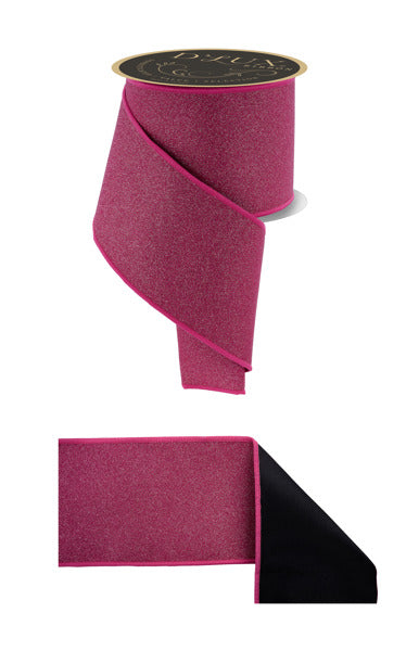a pink and black ribbon, with the pink ribbon being the main focus. The ribbon appears to be a decorative item, possibly used for wrapping or tying objects.