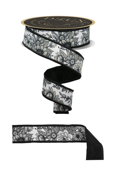 a black and white floral patterned ribbon with a gold-colored label.