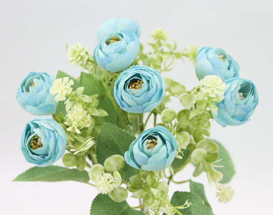 a vase filled with blue flowers on top of a table