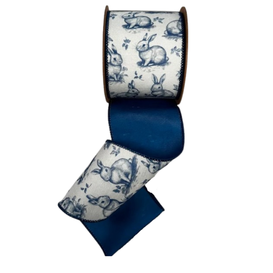 a roll of ribbon with a repeating pattern of white rabbits on a blue background.