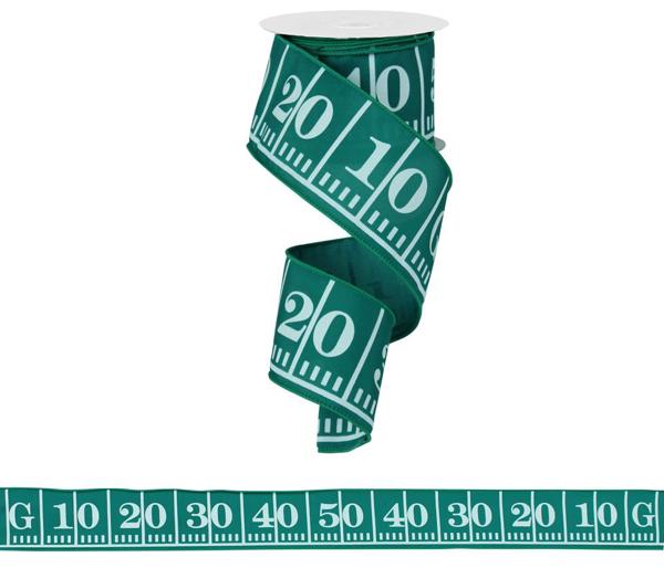 A green football field measuring ribbon with the numbers "10 20 30 40 50 60 70 80 90 100" printed on it, along with a measuring tape.